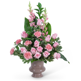 Pink roses and carnations in a ceramic vase