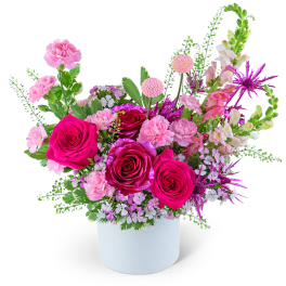 Pink and magenta rose arrangement in a white vase