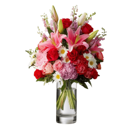 Mixed bouquet of pink lilies, red roses, and daisies in a clear glass vase