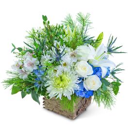 White and blue floral arrangement in a rustic wooden container