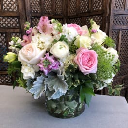 Pink and white mixed flower arrangement in a glass vase