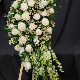 White rose standing spray on a wooden easel