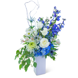 Blue and white floral arrangement in a white vase