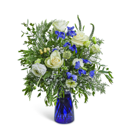 White roses and blue flowers in a blue glass vase
