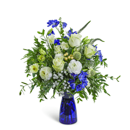 Blue and white floral arrangement in a cobalt glass vase