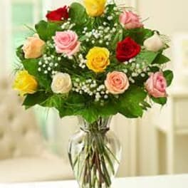 Bouquet of multicolored roses in a clear glass vase
