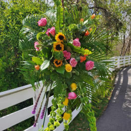 Large tropical floral standing spray with roses and sunflowers