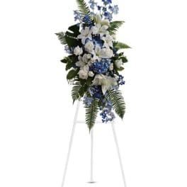 White and blue floral standing spray on a metal easel