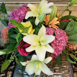 Bouquet of white lilies, pink hydrangeas, and mixed roses