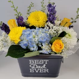 Mixed bouquet in a dark container labeled Best Dad Ever