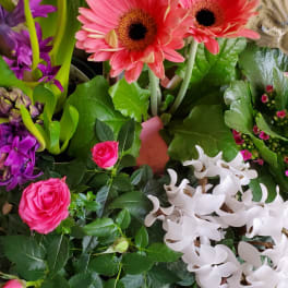 Mixed bouquet with pink gerbera daisies, roses, and purple flowers