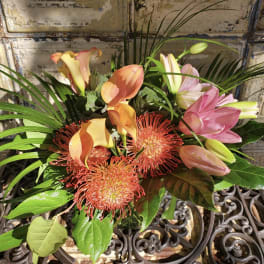 Bouquet with pink calla lilies and orange pincushion blooms