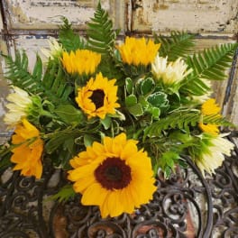 Bouquet of yellow sunflowers with mixed greenery