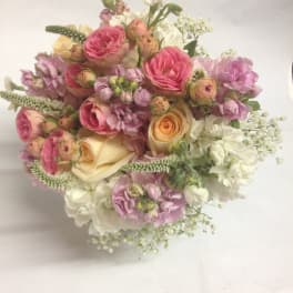 Bouquet of pink and cream roses with white filler flowers