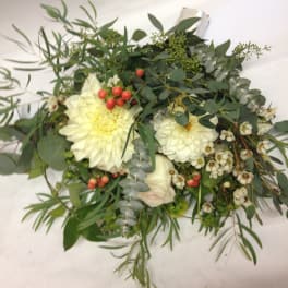 White flower bouquet with greenery and red berries