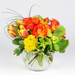 Orange and yellow rose bouquet in a clear glass vase