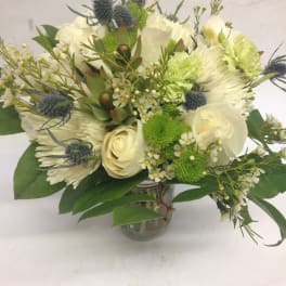 White and green bouquet with roses and chrysanthemums in a glass vase