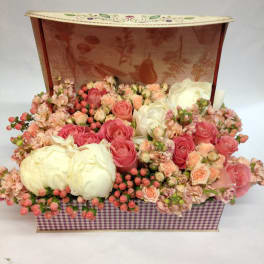 Pink and white rose arrangement in a decorative gift box