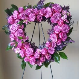 Pink rose wreath on a black stand