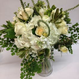 White and cream floral arrangement in a clear glass vase