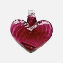 Heart-shaped red glass bottle with a small stopper