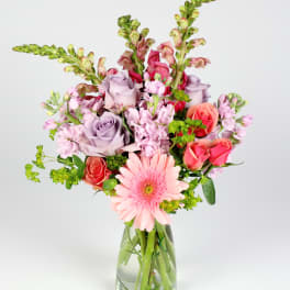 Pink and lavender mixed bouquet in a clear glass vase
