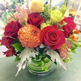 Mixed bouquet of roses and dahlias in a glass vase