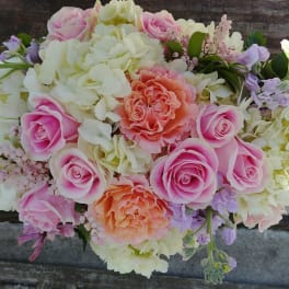 Pink and peach roses with white hydrangeas in a bouquet