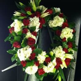 Heart-shaped wreath of red roses and white flowers