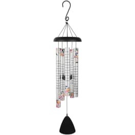 Metal wind chime with silver tubes printed with script and pastel floral accents hanging from a black top.