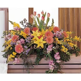 Large mixed floral arrangement with tulips, lilies, and daisies