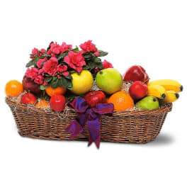 Fruit basket with pink flowers and a purple ribbon