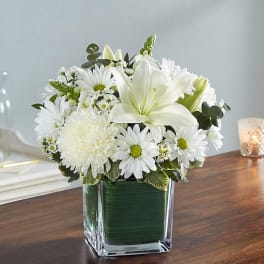 White flowers arranged in a square glass vase
