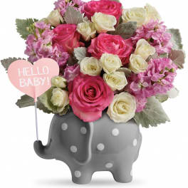 Pink and white rose bouquet in a gray elephant vase with a "Hello Baby!" sign