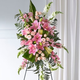 Standing floral spray with pink lilies, roses, and white snapdragons