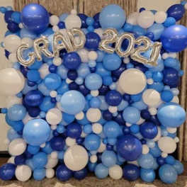 Blue and white balloon backdrop with silver "GRAD 2021" letters
