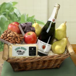 Gift basket with pears, apples, almonds, cheese, chocolate, and a sparkling bottle