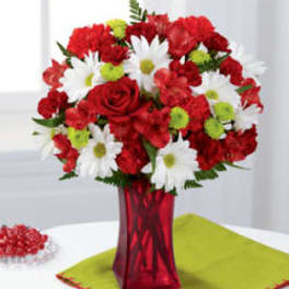 Red and white flower bouquet in a red vase