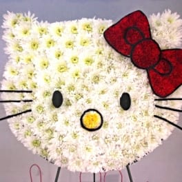 Hello Kitty face made of white flowers with a red bow