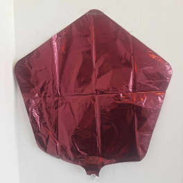 Deflated red foil balloon with angular shape against a white wall