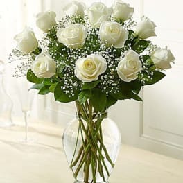 White roses arranged in a clear glass vase