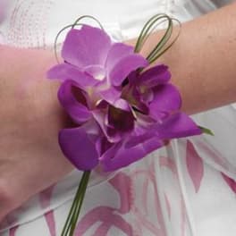 Purple orchid wrist corsage with looped wire accents