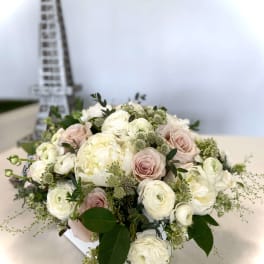 Blush and white bouquet of roses and ranunculus in a white box