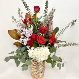 Red roses and white hydrangea in a metallic vase
