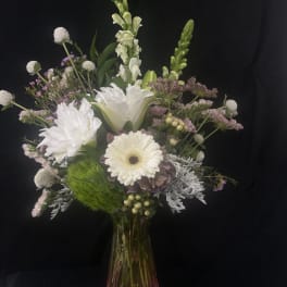 White and pale lavender mixed bouquet in a glass vase