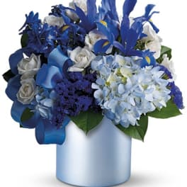 Blue and white floral arrangement in a light blue vase