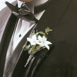 White boutonniere pinned to a black suit jacket