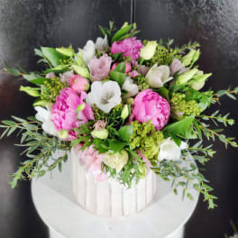 Pink and white bouquet in a white ribbed vase
