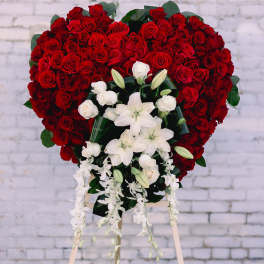 Heart-shaped red rose standing spray with white lilies and orchids