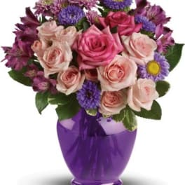 Pink and purple mixed bouquet in a purple vase